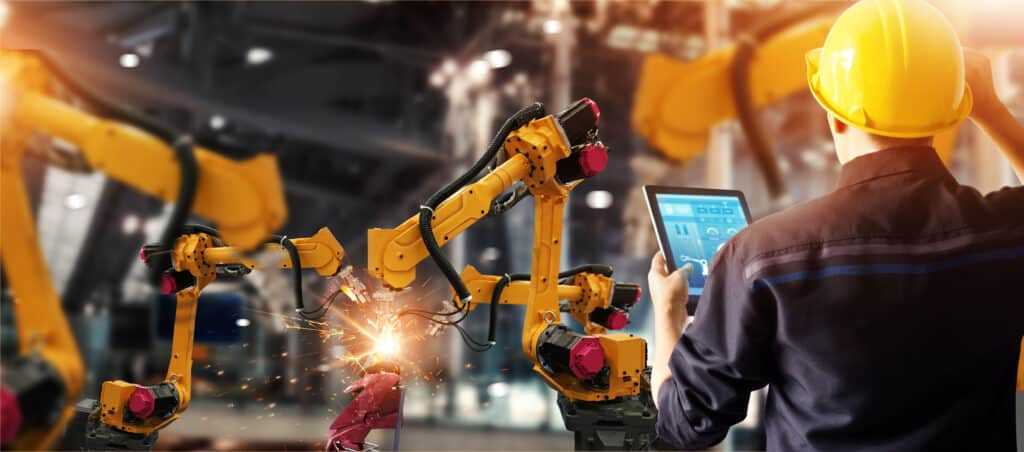 Manufacturing IT manager reviewing documentation to reduce operational risk